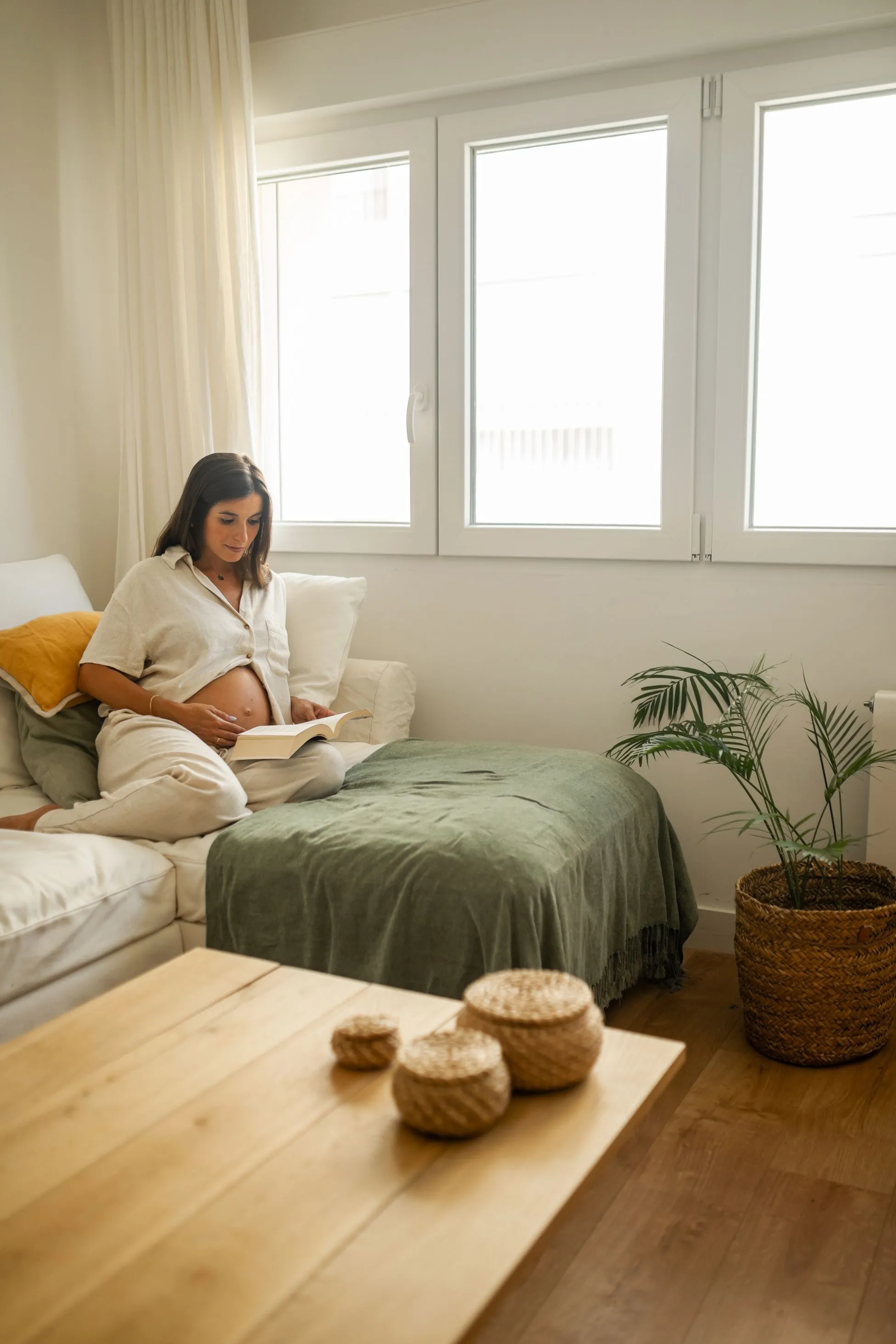 pregnant woman lounging and reading a book