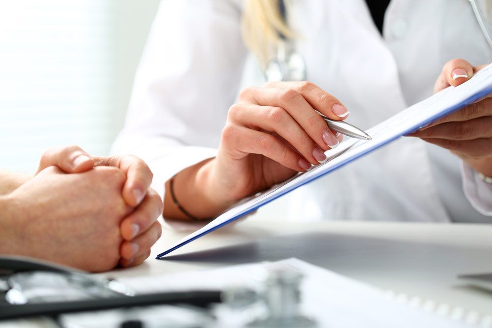 Medical professional and patient reviewing paperwork